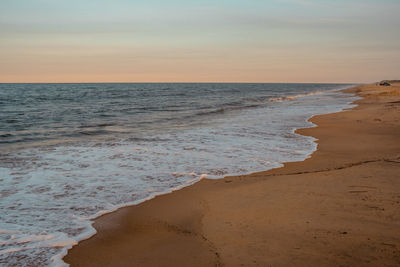 Scenic view of beach against sky during sunset