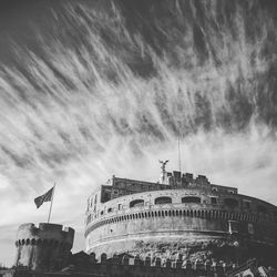 Low angle view of built structure against cloudy sky