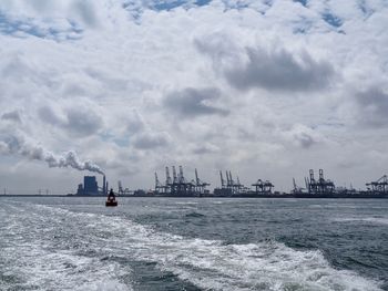 Ship sailing on sea against sky