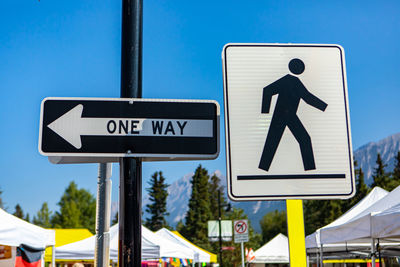 Road sign against blue sky