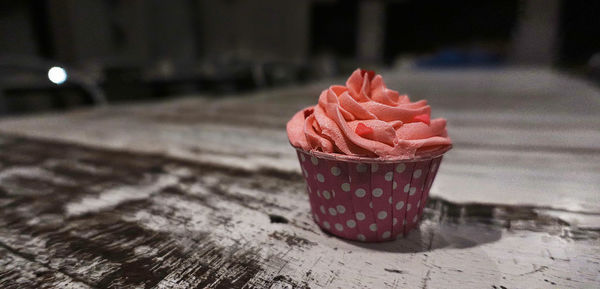 Close-up of ice cream in disposable cup on table