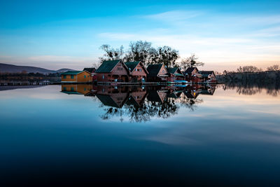 Scenic view of lake against sky at sunset