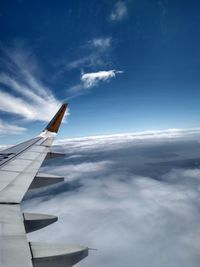 Airplane flying over cloudscape against sky