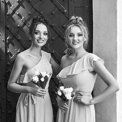 Portrait of smiling friends standing against wall