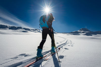 Full length of person skiing on snowcapped mountain against sky