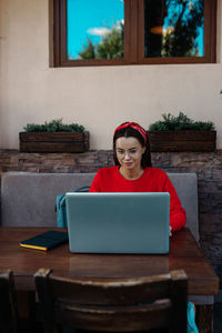 Portrait of woman sitting on table