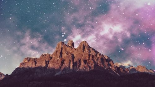 Scenic view of rock formation against sky at night