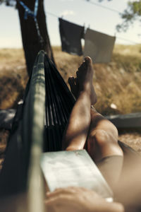 Low section of person relaxing on hammock