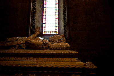 Tomb against window of building