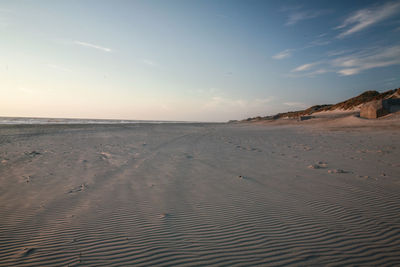 Scenic view of sandy beach against sky