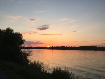 Scenic view of lake against sky during sunset