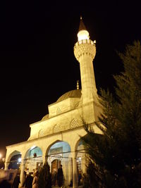 Low angle view of illuminated building against sky at night