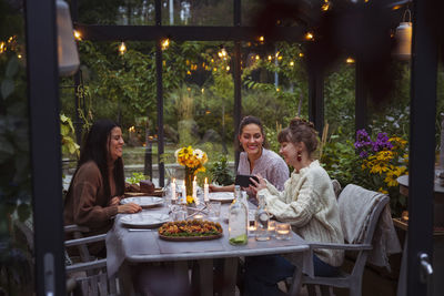 Rear view of woman having food at restaurant