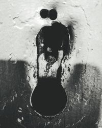 High angle view of water flowing through hole in wall