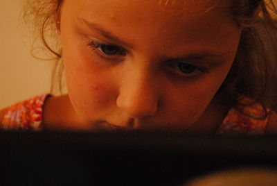 Close-up of girl using laptop