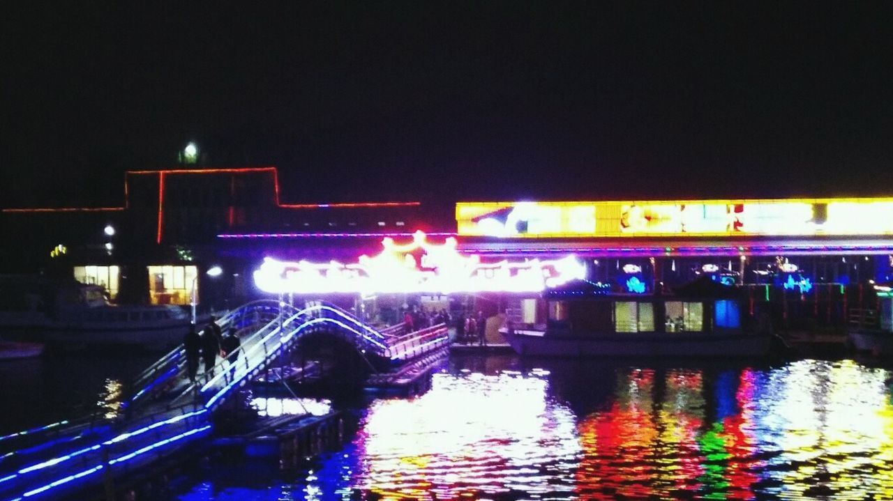 illuminated, night, water, reflection, transportation, waterfront, mode of transport, built structure, architecture, nautical vessel, boat, building exterior, river, city, multi colored, canal, bridge - man made structure, outdoors, no people, city life
