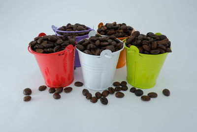 High angle view of coffee beans against white background