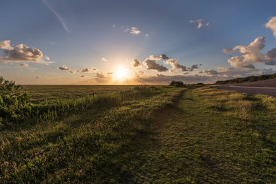 Scenic view of field against sky during sunset