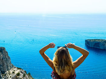 Rear view of woman against sea