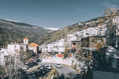 Buildings in city against sky during winter