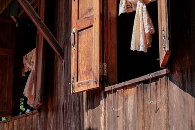 Low angle view of clothes hanging on old building