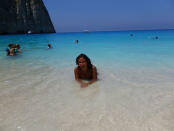 Woman on beach against clear sky