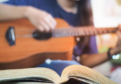 Close-up of man playing guitar