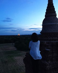 Rear view of man in front of sea