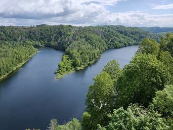 High angle view of river amidst trees against sky