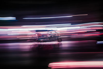 Light trails on road in city at night