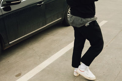 Low section of man standing on street