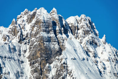 Snowy mountain rises above the alpe di campogrosso, vicenza, italy