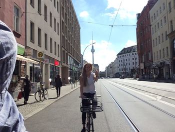 Rear view of woman walking on city street