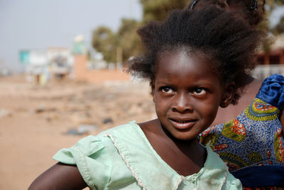 Close-up of girl looking away while standing outdoors