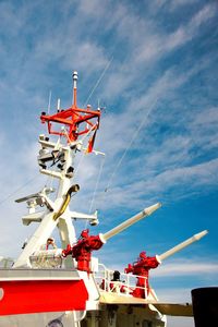 Low angle view of drilling rig against sky