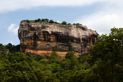 Low angle view of rock formation against sky