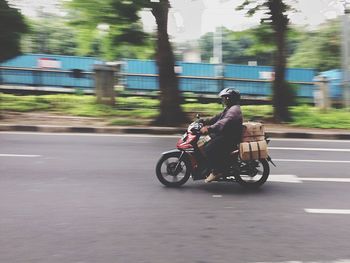 Man riding motorcycle on road