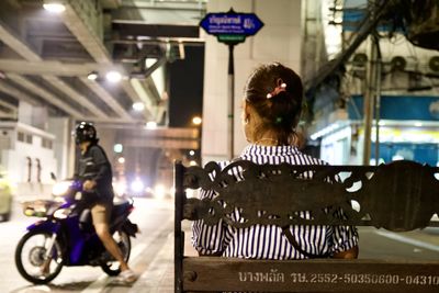 Rear view of woman riding motorcycle