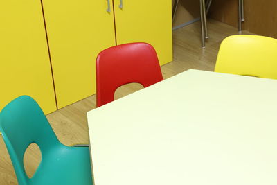 High angle view of empty chair on table