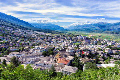 High angle view of townscape and mountains against sky