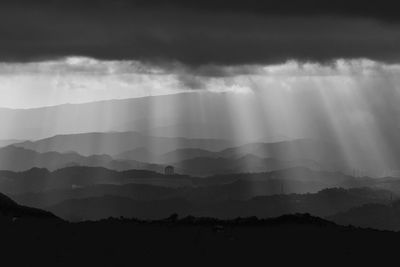 Scenic view of silhouette mountains against sky