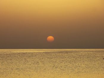 Scenic view of sea against sky at sunset