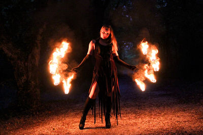 Woman with bonfire at night