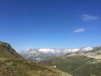 Scenic view of mountains against clear blue sky