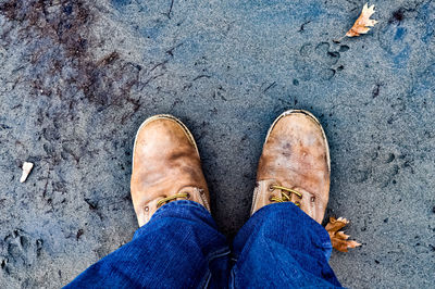 Low section of man standing on footpath