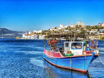 Boats in river with town in background