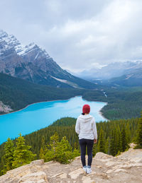 Rear view of woman standing on mountain