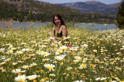 Young woman with flowers in field