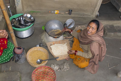 High angle portrait of woman preparing food at home