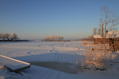 Houses by snowcapped landscape at dusk